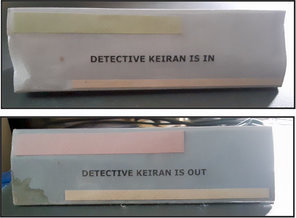 Photograph of two signs indicating whether Keiran is at her desk, or not