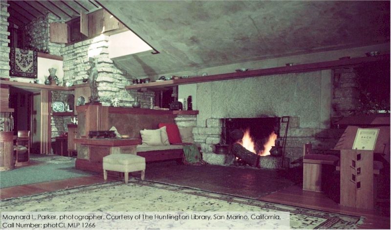 Color photograph taken of bench and fireplace in Taliesin living room, 1955.