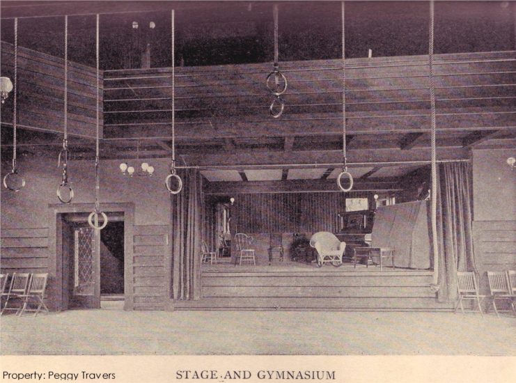Photograph looking east at the stage in the Hillside Home School gym.