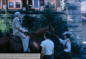 Color photograph--Frank Lloyd Wright at the Hillside Home School on a horse with his wife Olgivanna and apprentice, Joe Fabris. Photo by Bruce Brooks Pfeiffer.