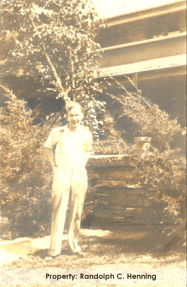 Photograph of Keith McCutcheon outside at a stone wall at Taliesin, c. 1932.