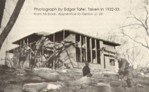 Black and white photograph by Edgar Tafel of people around Hillside building they are renovating.