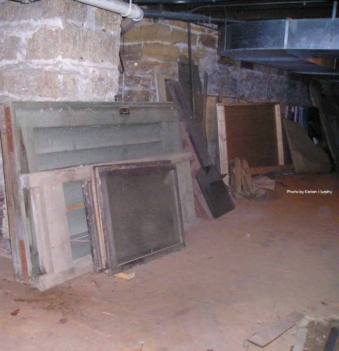 A dirt floor, stone walls and debris in the Hillside Home School basement. Photo by Keiran Murphy.