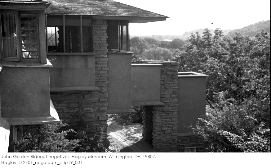 Black and white photo by John Gordon Rideout looking at exterior plaster and stone at Taliesin with leafy trees in the background.