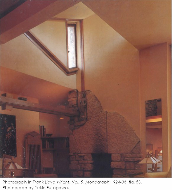 Photograph by Yukio Futagawa showing the corner of the Guest Bedroom in Taliesin. Has with beige walls, light fixtures and a mirror.