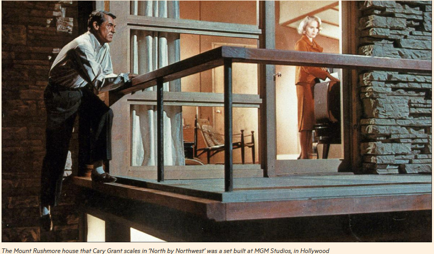 Screenshot from the movie North by Northwest. Cary Grant standing against terrace railing of Vandamm house
